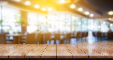 Empty wooden table top with lights bokeh on blur restaurant background. photo