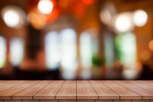 Empty wooden table top with lights bokeh on blur restaurant background. photo