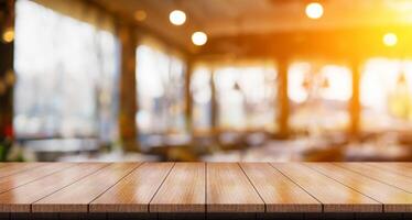 Empty wooden table top with lights bokeh on blur restaurant background. photo