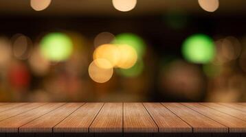 Empty wooden table top with lights bokeh on blur restaurant background. photo