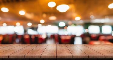 Empty wooden table top with lights bokeh on blur restaurant background. photo