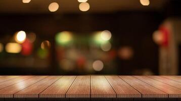 Empty wooden table top with lights bokeh on blur restaurant background. photo