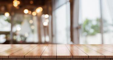 Empty wooden table top with lights bokeh on blur restaurant background. photo
