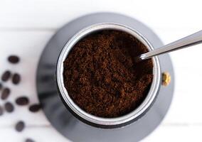 Fresh fragrant ground coffee in a geyser coffee maker. Brewing natural coffee in a geyser coffee maker. Top view. Selective focus. photo