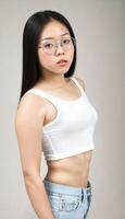 AI generated photo of beautiful young asian woman with crop white top and jeans an glasses standing at white backdrop, generative AI