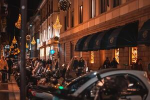 Blurred background of christmas street lights with people strolling with shopping bags in Milan, Italy 2.12.2023 photo