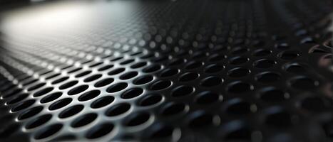 AI generated Macro shot of a black perforated metal surface with circular patterns photo