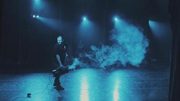 A stage worker fills the smoke scenes from the smoke machine. Preparation for a concert or performance. Life behind the scenes. video