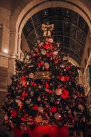 Milano Christmas. Christmas tree in the heart of Milan from Victoria Secret in Galleria del Corso. Night photography of the city. Milan, Italy 6.12.2023 photo