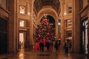 Milano Christmas. Christmas tree in the heart of Milan from Victoria Secret in Galleria del Corso. Night photography of the city. Milan, Italy 6.12.2023 photo