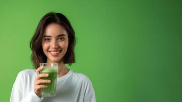 AI generated Healthy woman holding vegetable juice on green background photo