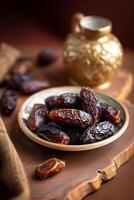 brown tasty dates inside plate on the wooden desk selective focus photo