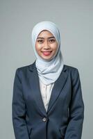young muslim businesswoman with positive expression smiling in isolated studio background photo