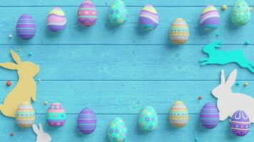 Easter eggs and rabbit silhouettes on a turquoise wooden background with scattered beads. video
