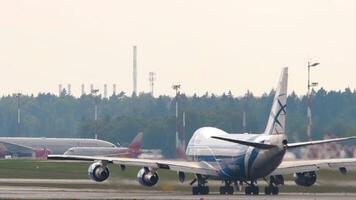 MOSCOW, RUSSIAN FEDERATION - JULY 30, 2021. Aircraft of AirBridgeCargo taking off at Sheremetyevo airport, rear view. Boeing 747 departure. Aviation concept video