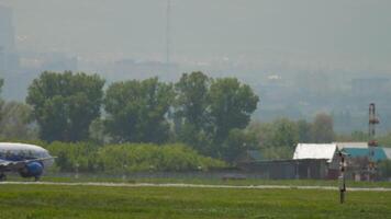 ALMATY, KAZAKHSTAN - MAY 5, 2019. Jet Boeing 737 of SCAT taxiing at Almaty International Airport, Kazakhstan, side view. Haze on the airfield video