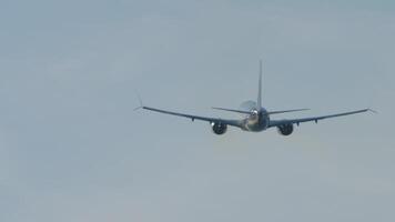 Rear view of a jet plane gaining altitude after takeoff. The airliner leaving. Airplane silhouette in the sky video