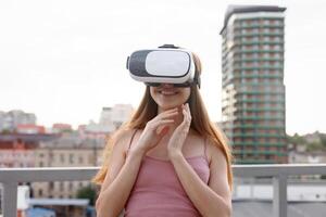 amazed young beautiful girl using new VR technology photo