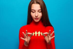 closeup of womans cupped hands showing paper man family photo