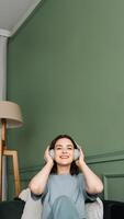 Rhythmic Relaxation. Woman Engrossed in Music for a Serene Weekend. Savoring Music Moments. Wireless Headphones Bring Weekend Joy to Woman photo
