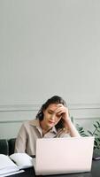 Work-Induced Weariness. Young Woman Suffers from Overwork and Stress. Modern-Day Struggles. Woman Overwhelmed by Overwork and Stress. Young Woman Sleeps at Laptop, Overworked and Stressed photo