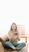 Surprised millennial reaction. Happy woman with open mouth looking at phone, reading message, playing mobile game. Expressive emotion, technology entertainment and modern lifestyle concept photo