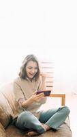 Joyful millennial woman with an open mouth, captivated by her phone. Engaged in playing mobile games, reading messages, and lively chatting in a chat room. Expressive Smartphone Interaction photo