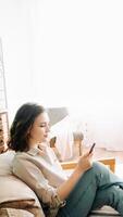 Connected and Content. Smiling Millennial Woman Engaged with Smartphone, Reading Messages, Chatting, and Enjoying Internet Surfing. Modern Communication and Social Media Lifestyle Concept photo