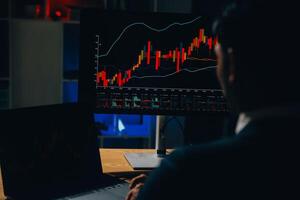 Thoughtful focused successful caucasian male stock investor, broker, financial adviser, sits at work desk, looks at computer, pensively analyze risks and prospects, rise or fall of cryptocurrency coin photo