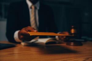 Judge gavel with Justice lawyers having team meeting at law firm background. Concepts of Law and Legal services. photo