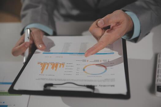 Business team working with new startup project plan and discussion information for financial strategy with laptop and digital tablet in a modern business lounge. photo