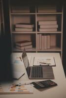 Laptop and paperwork on conference table photo