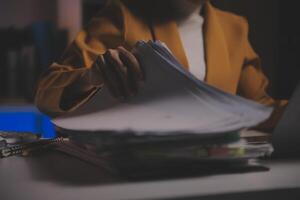 Business woman using calculator for do math finance on wooden desk in office and business working background, tax, accounting, statistics and analytic research concept photo