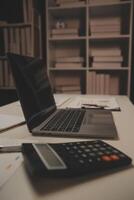 Laptop and paperwork on conference table photo