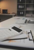 Laptop and paperwork on conference table photo