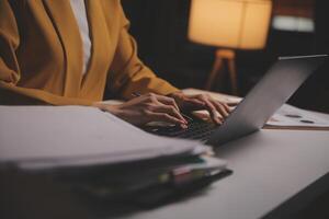 Business woman using calculator for do math finance on wooden desk in office and business working background, tax, accounting, statistics and analytic research concept photo