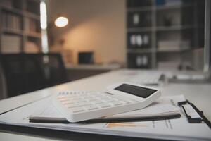 Laptop and paperwork on conference table photo