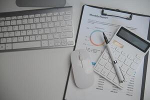 Laptop and paperwork on conference table photo