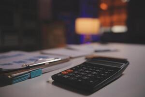 Business woman using calculator for do math finance on wooden desk in office and business working background, tax, accounting, statistics and analytic research concept photo