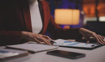 Business woman using calculator for do math finance on wooden desk in office and business working background, tax, accounting, statistics and analytic research concept photo