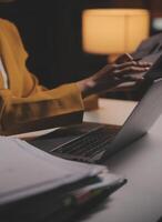 Business woman using calculator for do math finance on wooden desk in office and business working background, tax, accounting, statistics and analytic research concept photo