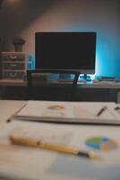 Laptop and paperwork on conference table photo