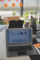 Business team meeting working with new startup project, discussion and analysis data the charts and graphs. Digital tablet, calculator, laptop computer using, Business finance and accounting concept. photo