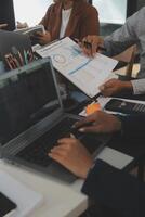 Business team meeting working with new startup project, discussion and analysis data the charts and graphs. Digital tablet, calculator, laptop computer using, Business finance and accounting concept. photo