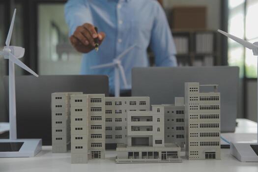 Close-up at tablet, Engineers pointing at tablet with their hands. To jointly design the use of renewable energy with wind and solar energy. Concept of using renewable energy. photo