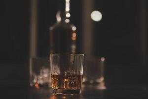 Celebration night, pour whiskey into a glass. Give to friends who come to celebrate photo