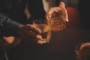 Celebration night, pour whiskey into a glass. Give to friends who come to celebrate photo