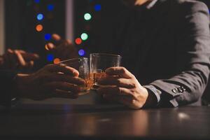 Celebration night, pour whiskey into a glass. Give to friends who come to celebrate photo