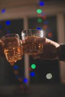 Celebration night, pour whiskey into a glass. Give to friends who come to celebrate photo