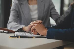 Lawyer, legal advisor, businessman brainstorming information on agreement details Business contracts in legal processing books for accuracy in contract documents. joint financial investment. photo